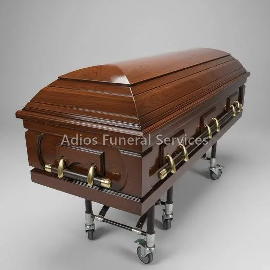 Mahogany casket with brass bar handles on a church trolley